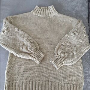 Elegant Cream Sweater with Textured Sleeves